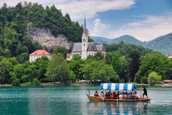 Hop on a pletna boat ride on Lake Bled.
